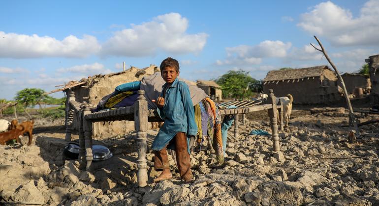 Crianças nos escombros de casa após cheias no Paquistão, 2022